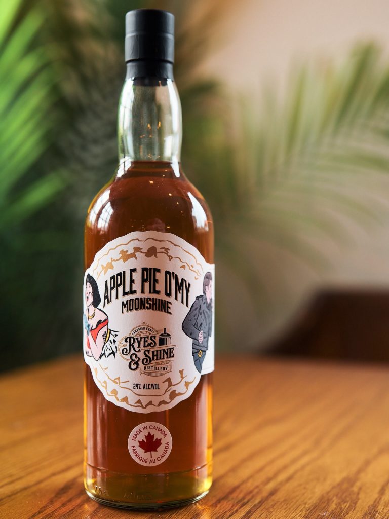 Apple Pie O’My Moonshine bottle on a wooden table