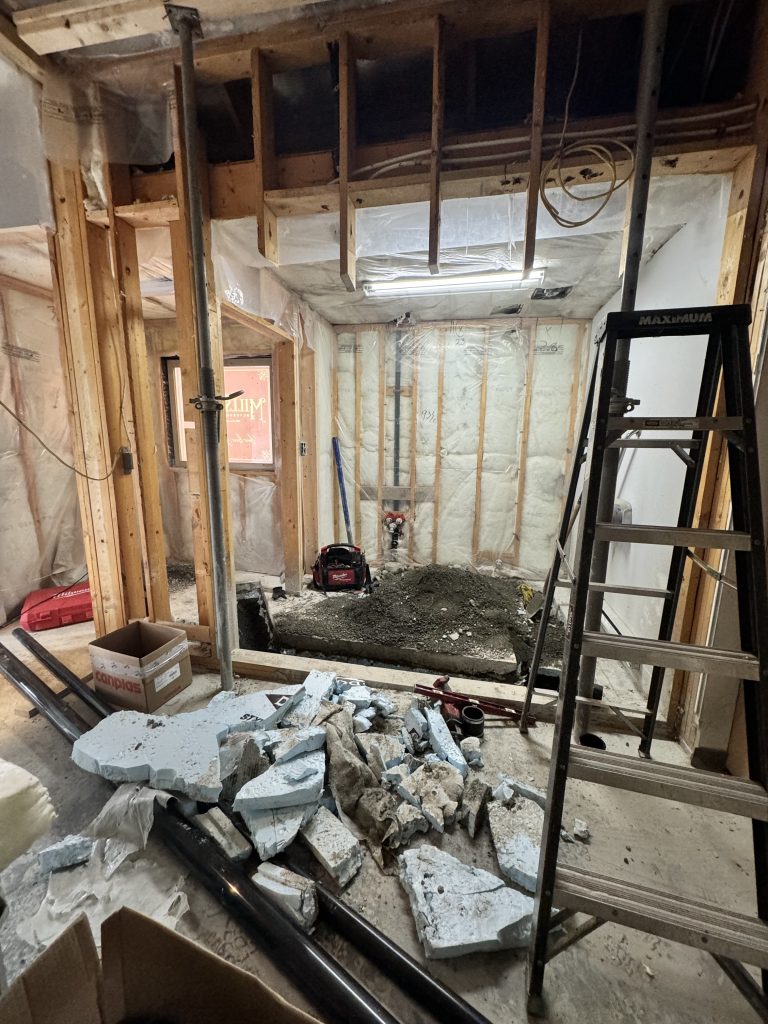 Exposed framing and construction work during the distillery renovation