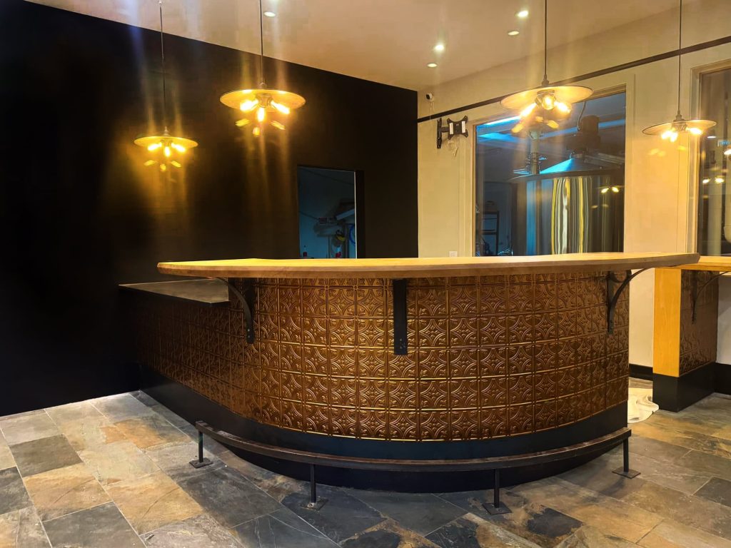The copper-toned bar and pendant lights during the distillery fit-out
